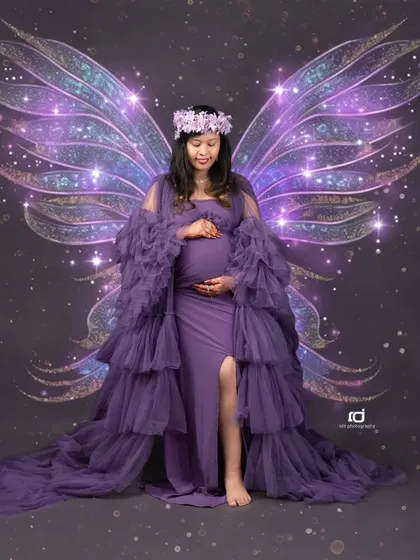 A touch of fantasy for your maternity shoot. With added fairy wings, this portrait in a purple gown transforms the mom-to-be into a magical guardian for her unborn child.