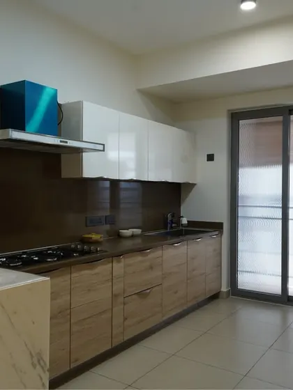 This angle shows the breakfast bar at the end of the kitchen counter, providing a convenient spot for a quick meal with a view.