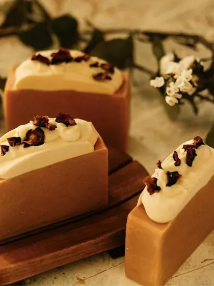 These soap bars look good enough to eat. The "frosting" on top is extra soap batter, piped on by hand and sprinkled with botanicals. It’s a little touch that makes each bar unique.