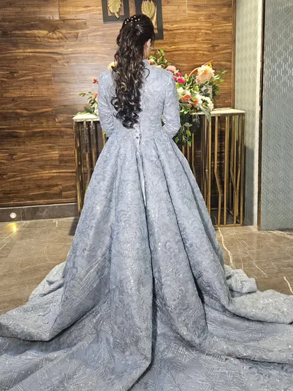 The back of the engagement gown, showing the dramatic train and the beautiful ponytail hairstyle we created.