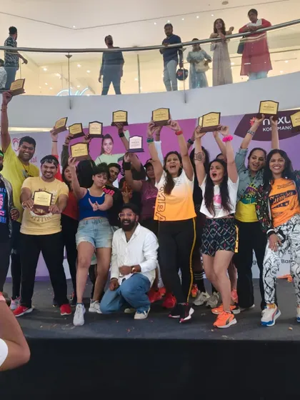 The entire team of instructors holding up their awards in celebration. This shows the strong network of professionals I work with to deliver large-scale, high-quality events.