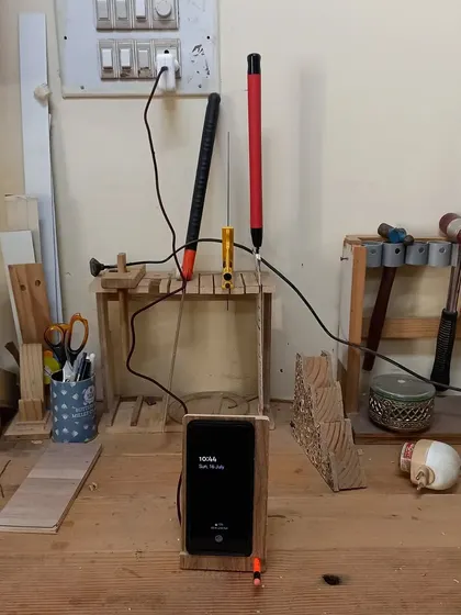 The wireless charging mobile stand in action. The most critical part of this build was routing out the wood to be just a millimeter thick over the charging coil.