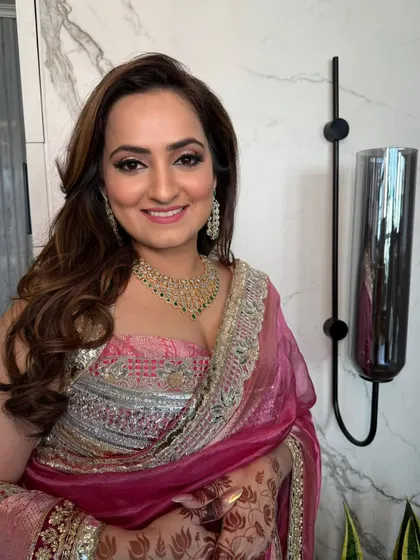 A happy client ready for her event with perfectly styled hair.