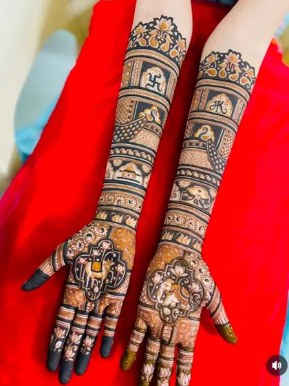 This design combines sacred symbols like the Swastika and Om with figures of a bride and groom, creating a mehndi that is both personal and auspicious.