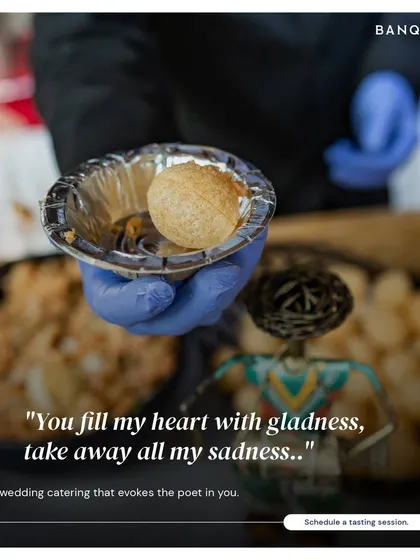 A server offering a guest a fresh pani puri. Our live chaat stations are always a hit, bringing the authentic, vibrant flavors of Indian street food to your event.