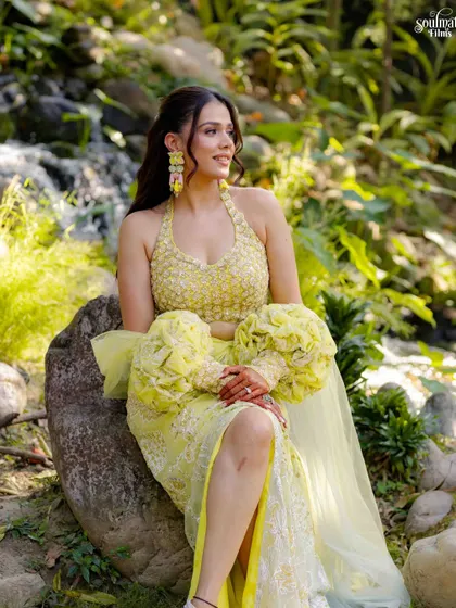 A serene portrait of the bride during her outdoor Haldi event. Her contemporary yellow lehenga and the natural setting create a beautiful, modern bridal look.