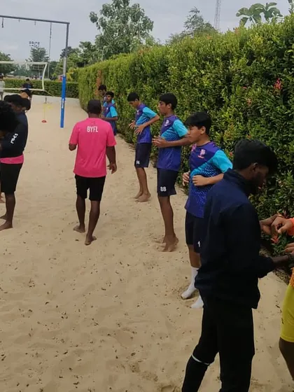 Players warming up on the sand court. This type of training is excellent for building explosive power and preventing injuries.