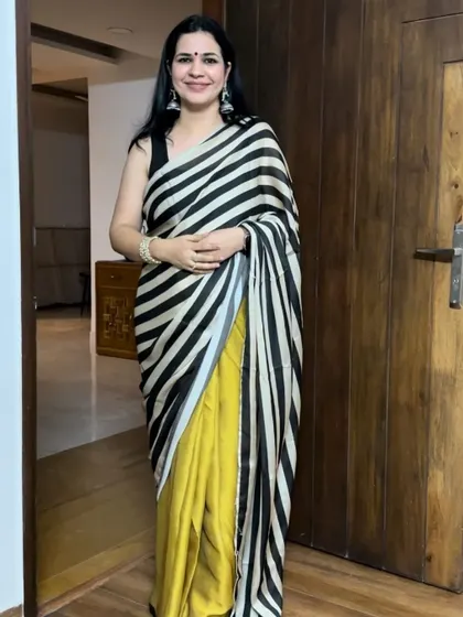This black and yellow striped saree is such a bold and modern choice. It's a great example of how you can play with prints and colors in your saree collection.