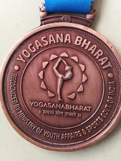 A close up of the Yogasana Bharat national championship medal. It is recognized by the Ministry of Youth Affairs & Sports, Govt. of India, signifying its official status.