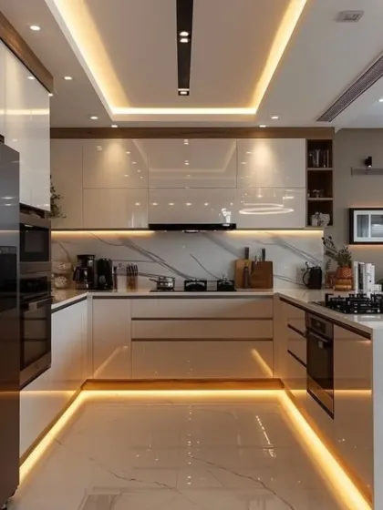 Luxury is in the details of this kitchen, which features high-gloss white cabinets, a marble backsplash, and layered ceiling and floor lighting. The design creates a bright, glamorous space that is perfect for entertaining.