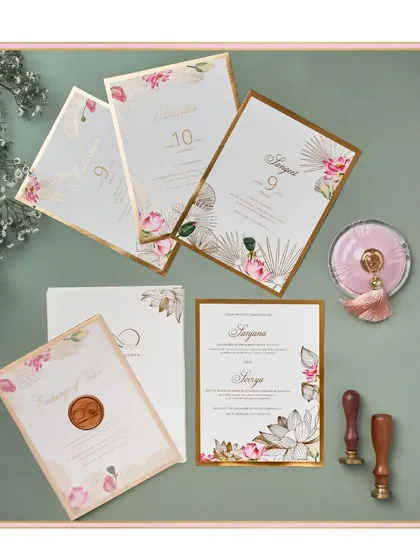 We call this design 'minimalistic grandeur'. It features delicate lotus illustrations with clean typography and gold foil borders, creating a look that is both simple and luxurious.