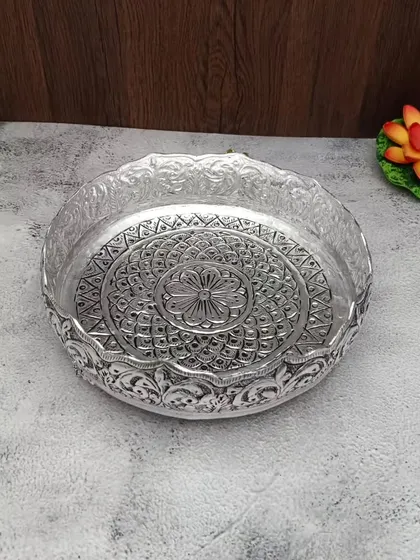 A duplicate image of the antique German silver urli with a central flower design.