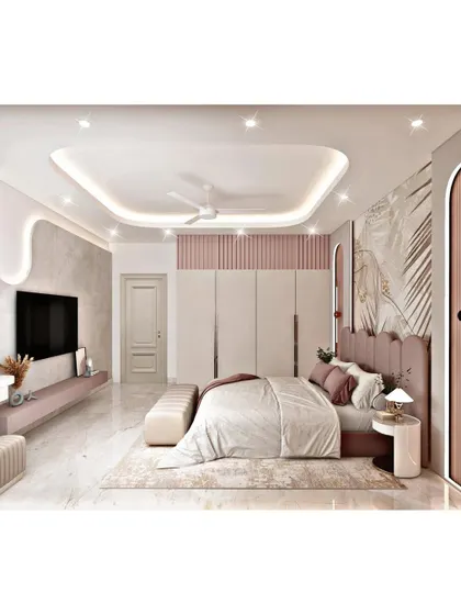 Another view of the blush pink bedroom, highlighting the full-length wardrobes and the TV unit. We design for both aesthetics and practicality, ensuring ample storage is seamlessly integrated into the room's style.