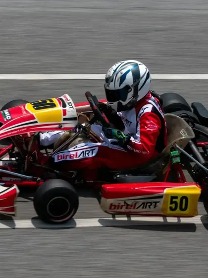 Kart number 50 at full speed on the main straight. The sleek aerodynamic profile of the BirelART chassis is designed to cut through the air for maximum velocity.