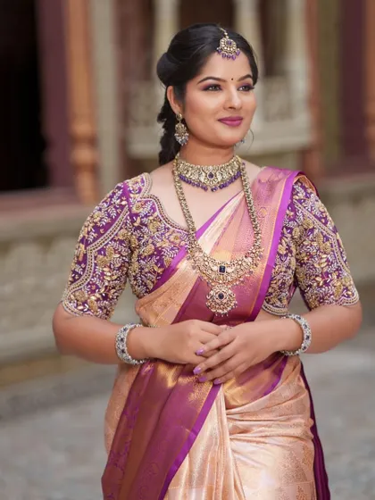 This beautiful Kanchi pattu saree in peach and purple is a classic choice for mothers of the bride or groom.