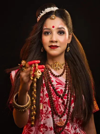 A student's interpretation of Maa Brahmacharini, the ascetic goddess. The look is simple yet powerful, using rudraksha beads and minimal makeup to convey devotion and penance.