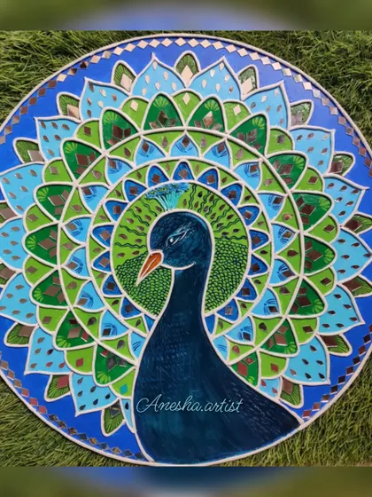 A top-down view of the peacock Lippan art, highlighting the symmetry of the mandala design.