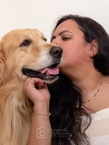 A sweet kiss for a beautiful golden retriever. These are the candid, love-filled moments that make for the most cherished family photos.