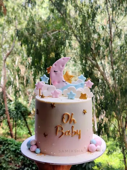 A closer look at my "Oh Baby" moon and stars cake. The soft colors and sweet details make it a perfect centerpiece for celebrating a baby on the way.