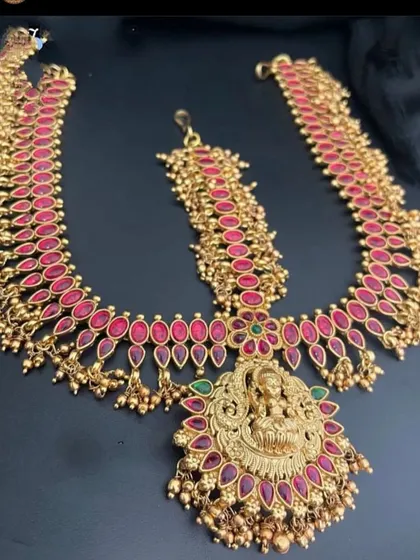 A grand, three-layer maang tikka with a large central pendant featuring a goddess motif. This piece is designed to be the highlight of your bridal headwear.