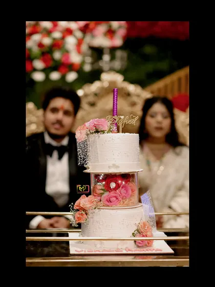 Even the cake gets its moment. This shot focuses on the beautifully designed engagement cake, with the happy couple blurred in the background, adding context and depth to the photo.