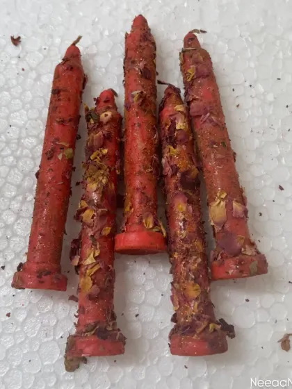 Let the divine glow of Navratri brighten your space. These red taper candles are dressed in rose petals and herbs, infused with love and devotion for the festival.