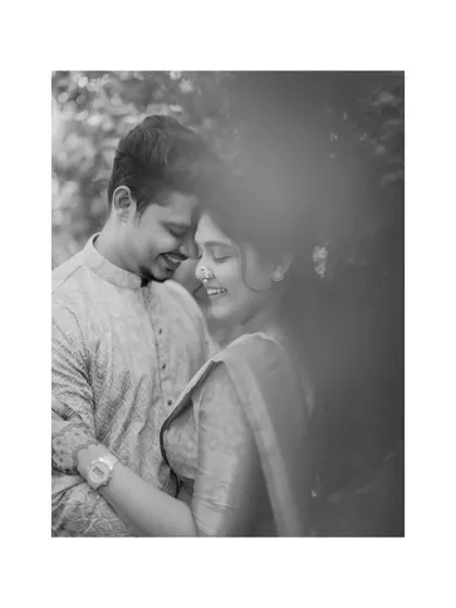 An intimate black and white portrait of the couple sharing a quiet, happy moment together during their engagement photoshoot.
