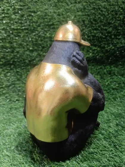 A back view of the smoking chimpanzee showpiece, showing the detail on the golden t-shirt.