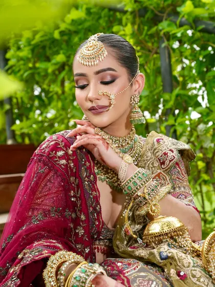 A truly ethereal queen. This shot captures the perfection of her radiant skin and regal finish, with soft, closed eyes showcasing the blended eyeshadow and the intricate details of her jewellery.