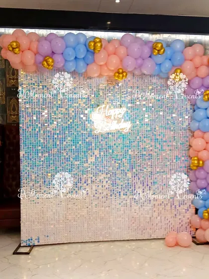 This shimmering sequin wall, framed by pastel balloons, provides a glamorous and fun photo backdrop for a unicorn or rainbow-themed party.