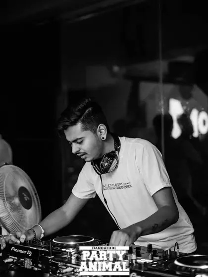 A black and white shot that captures the mood and focus of a DJ at work. It's all about the music and the craft.