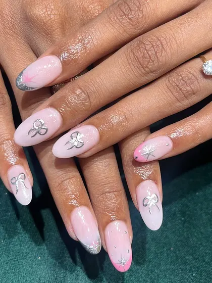 A closer look at these birthday nails. The 3D silver bows and chrome French tips create a festive and glamorous look, perfect for any celebration.