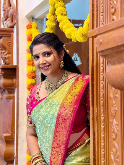 The complete look, with the actress framed by a traditionally decorated doorway.