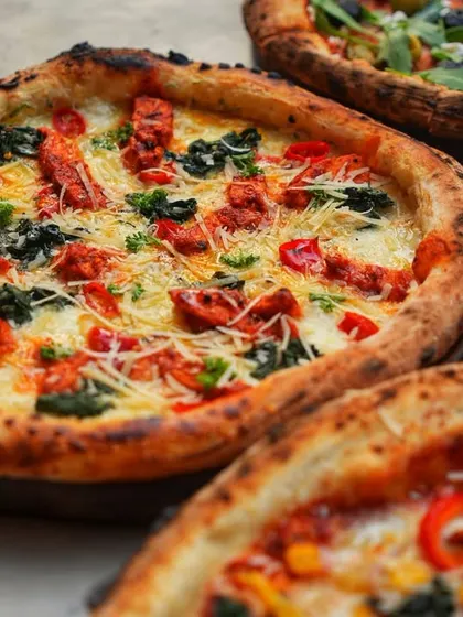 Sometimes, a picture of a perfect pizza spread is all you need. This image captures a table full of our delicious wood-fired pizzas and fresh pasta.