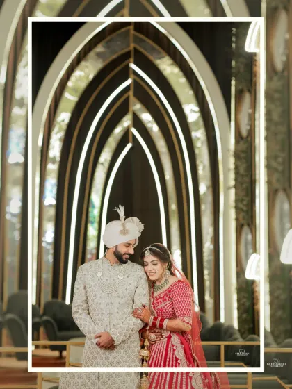 The couple shares a quiet moment amidst the stunning, modern architecture of their wedding venue. The arches create a beautiful frame for this portrait.