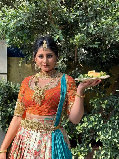 A similar pose from the Ugadi shoot, highlighting the beautiful jewelry and vibrant colors of the outfit.