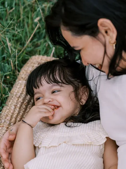 A mother and daughter sharing a laugh while lying on a picnic blanket. These candid moments of connection are my favorite.