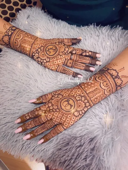 This engagement design features the couple's intertwined initials in the center of the palms, surrounded by intricate floral and check patterns.