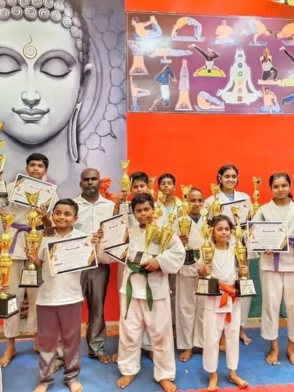 A group of our state-level karate champions, proudly displaying their trophies and certificates after a fantastic performance.