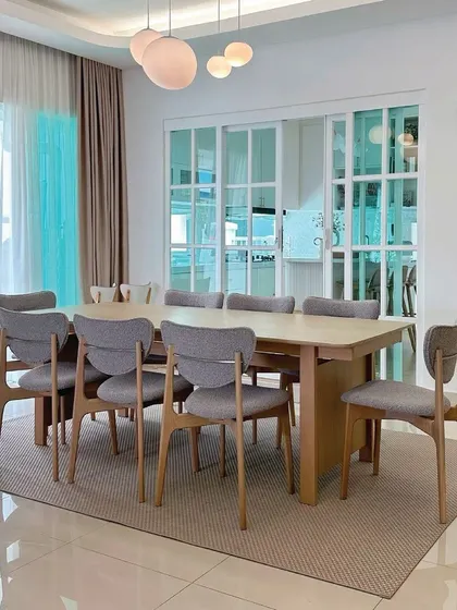The Copenhang Dining Set in a customer's bright and airy home. The extendable solid oak table and elegant side chairs in grey boucle fabric perfectly embody the clean lines and functional beauty of Scandinavian design.