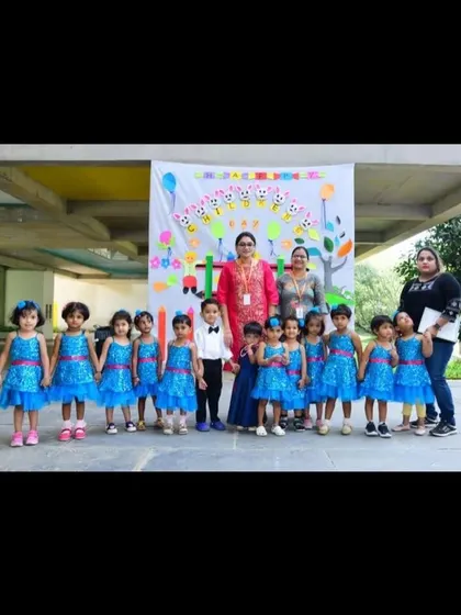 A dazzling group of young performers in sparkly blue dresses, designed to catch the light and add a touch of magic to their stage presence.
