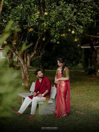 A relaxed and natural couple portrait taken in a beautiful park. The greenery and soft light create a serene and romantic atmosphere for the photoshoot.