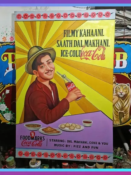The Raj Kapoor poster displayed in my workshop, flanked by other colorful paintings. This shows how different pieces look together.
