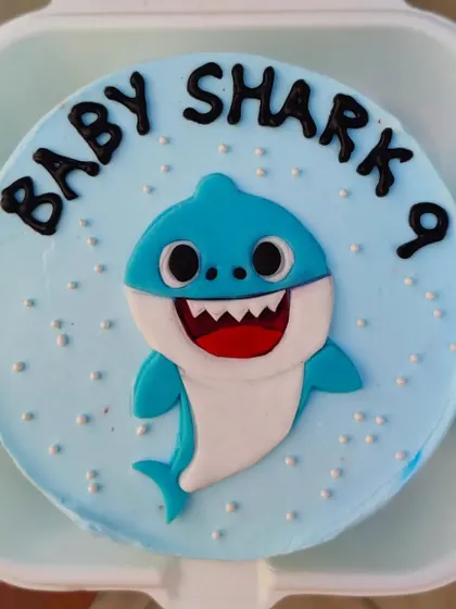 A sweet Baby Shark bento cake for a 9-month celebration. It's a great way to mark those little milestones with a fun and popular theme.