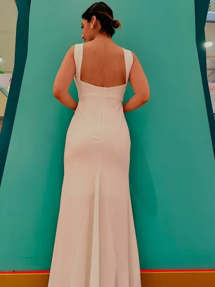 A back view of my white dress, showing the elegant low-back design. Your image is your silent introduction.