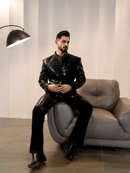 Another look at the black sequined jacket, a timeless piece for any cocktail or evening event. The textural fabrication and metallic embellishments are pure luxury.