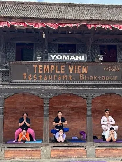Partner yoga in front of a temple view restaurant in Bhaktapur, Nepal. We find unique and beautiful places to practice together.