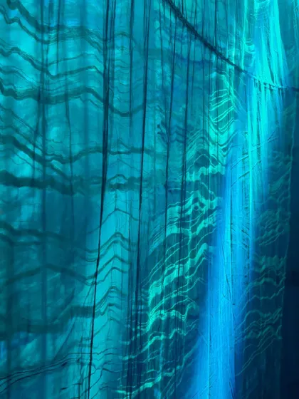 Light plays across the surface of the woven blue textiles in 'Into The Deep'. The effect mimics the way sunlight filters through water, creating a magical and mysterious landscape.