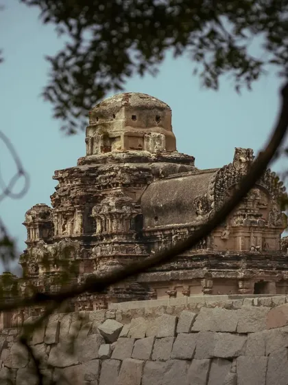 A temple in Hampi framed by tree branches. Using natural frames like this adds depth and a sense of discovery to my architectural photography.