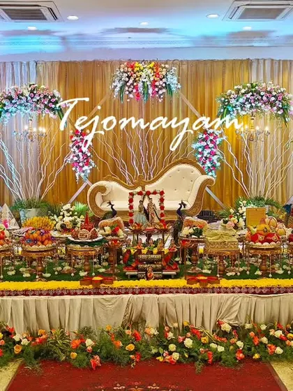An elegant engagement stage with a backdrop of white branches and flowers, creating a whimsical and romantic atmosphere.